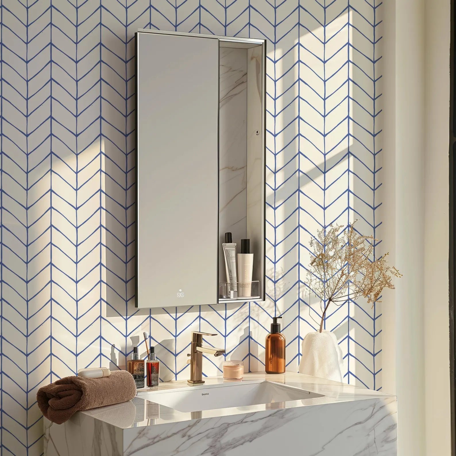 a bathroom with a white marble sink, a mirror, and various toiletries and decorative items on the counter.