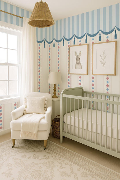 a cozy nursery room with a white crib, a white armchair, and a lamp. The room has a striped wallpaper and a wicker pendant light hanging from the ceiling. There is a window in the room, and the walls are decorated with two framed pictures of rabbits.