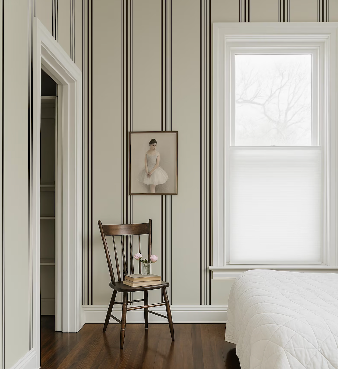 a serene bedroom scene with a wooden chair, a framed painting of a ballerina, and a window with white blinds.