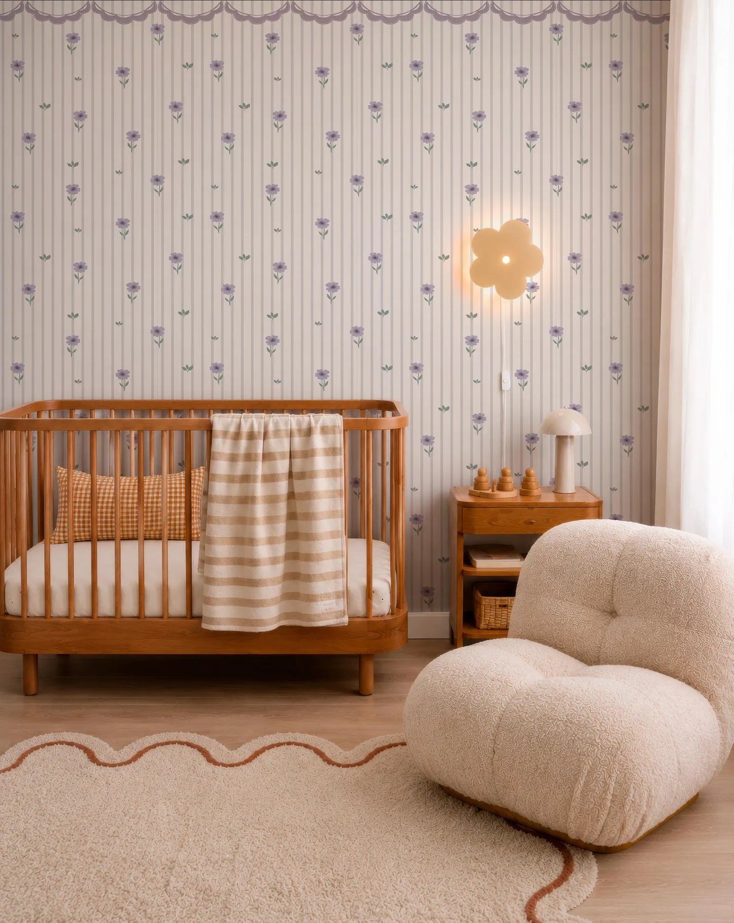 a cozy nursery room with a wooden crib, a plush chair, and a wallpapered wall with a flower pattern.
