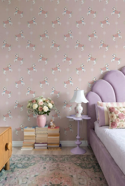 a bedroom with a pink and white patterned wallpaper, a purple bed with a white headboard, a pink nightstand with a vase of flowers and a stack of books, and a white lamp on a purple base.