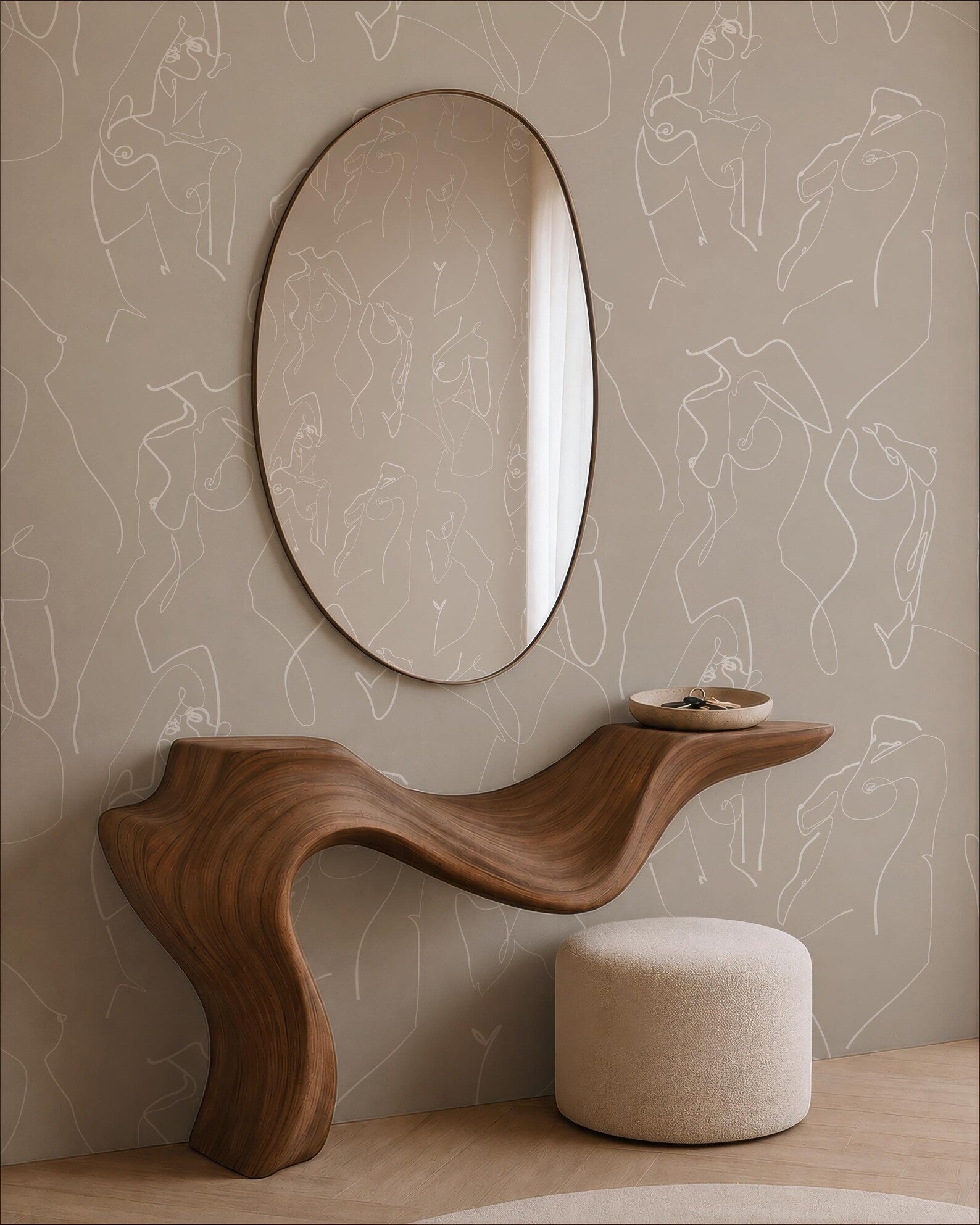 a modern and minimalist interior design with a wooden console table, a round mirror, and a beige ottoman. The console table has a curved, organic shape that complements the overall design aesthetic. The round mirror is positioned above the console table, creating a focal point in the space. The beige ottoman adds a touch of warmth and comfort to the room. The wall behind the furniture is adorned with abstract art, which further enhances the contemporary style of the space.