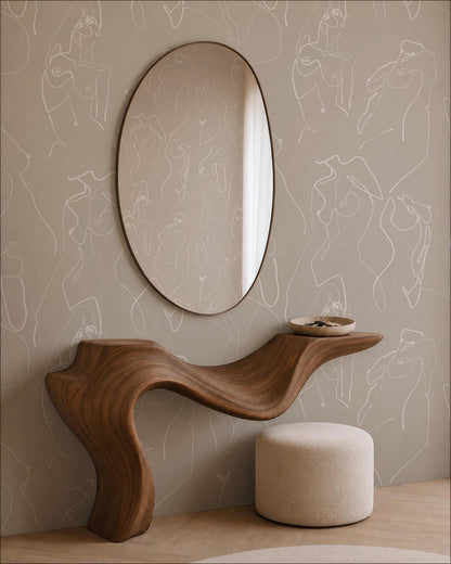 a modern and minimalist interior design with a wooden console table, a round mirror, and a beige ottoman. The console table has a curved, organic shape that complements the overall design aesthetic. The round mirror is positioned above the console table, creating a focal point in the space. The beige ottoman adds a touch of warmth and comfort to the room. The wall behind the furniture is adorned with abstract art, which further enhances the contemporary style of the space.
