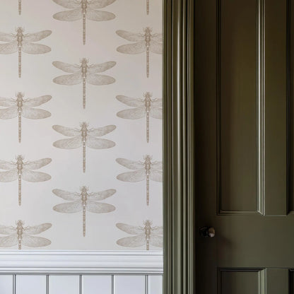 a wall with a repeating pattern of dragonflies, creating a visually striking and intricate design. The wall is painted in a light color, which complements the dragonfly pattern. The dragonfly pattern is also present on the door, adding a unique touch to the overall design.