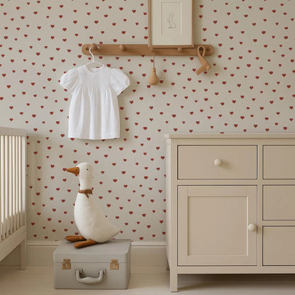 a nursery room with a white dresser, a stuffed duck toy, and a framed picture on the wall.