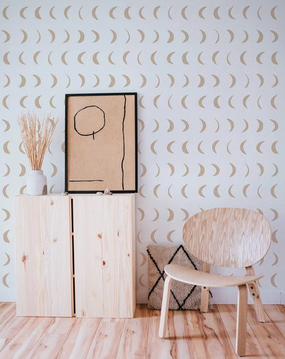 a minimalist interior design with a wooden chair, a wooden cabinet, and a framed artwork on a wall with a repeating pattern of crescent moons.