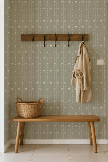 a wooden bench with a wicker basket on it, placed against a wall with a coat rack and a beige coat hanging on it.