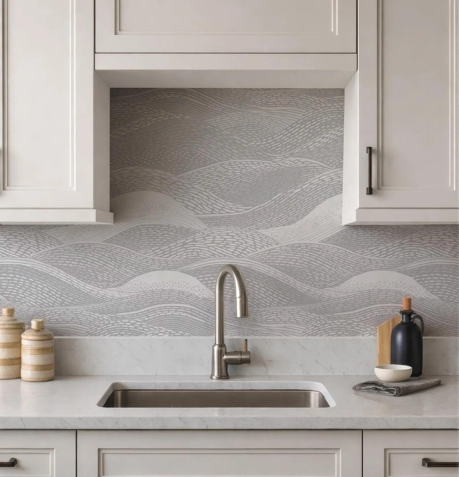 a modern kitchen with a sink, cabinets, and a decorative backsplash with a wave pattern.