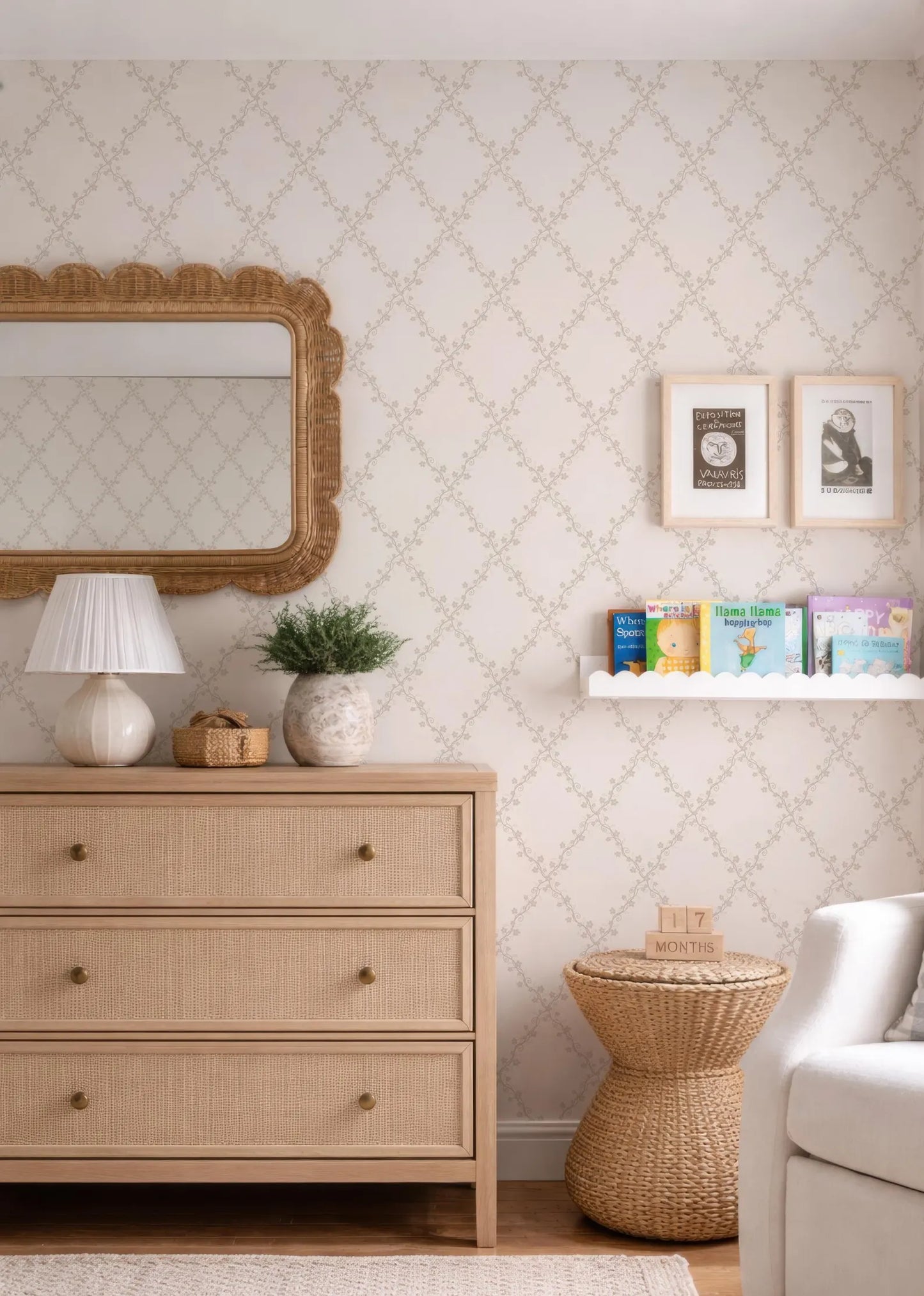 a cozy and well-decorated nursery room with a wooden dresser, a mirror, and a bookshelf filled with children's books.