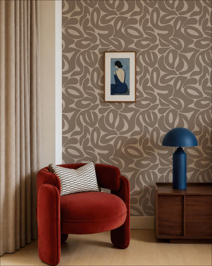 a modern living room with a red armchair, a wooden side table with a blue lamp, and a framed artwork on the wall.