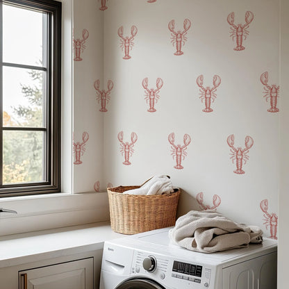 a laundry room with a white washing machine and a basket of clothes on the counter. The wall behind the washing machine has a repeating pattern of red lobster illustrations.