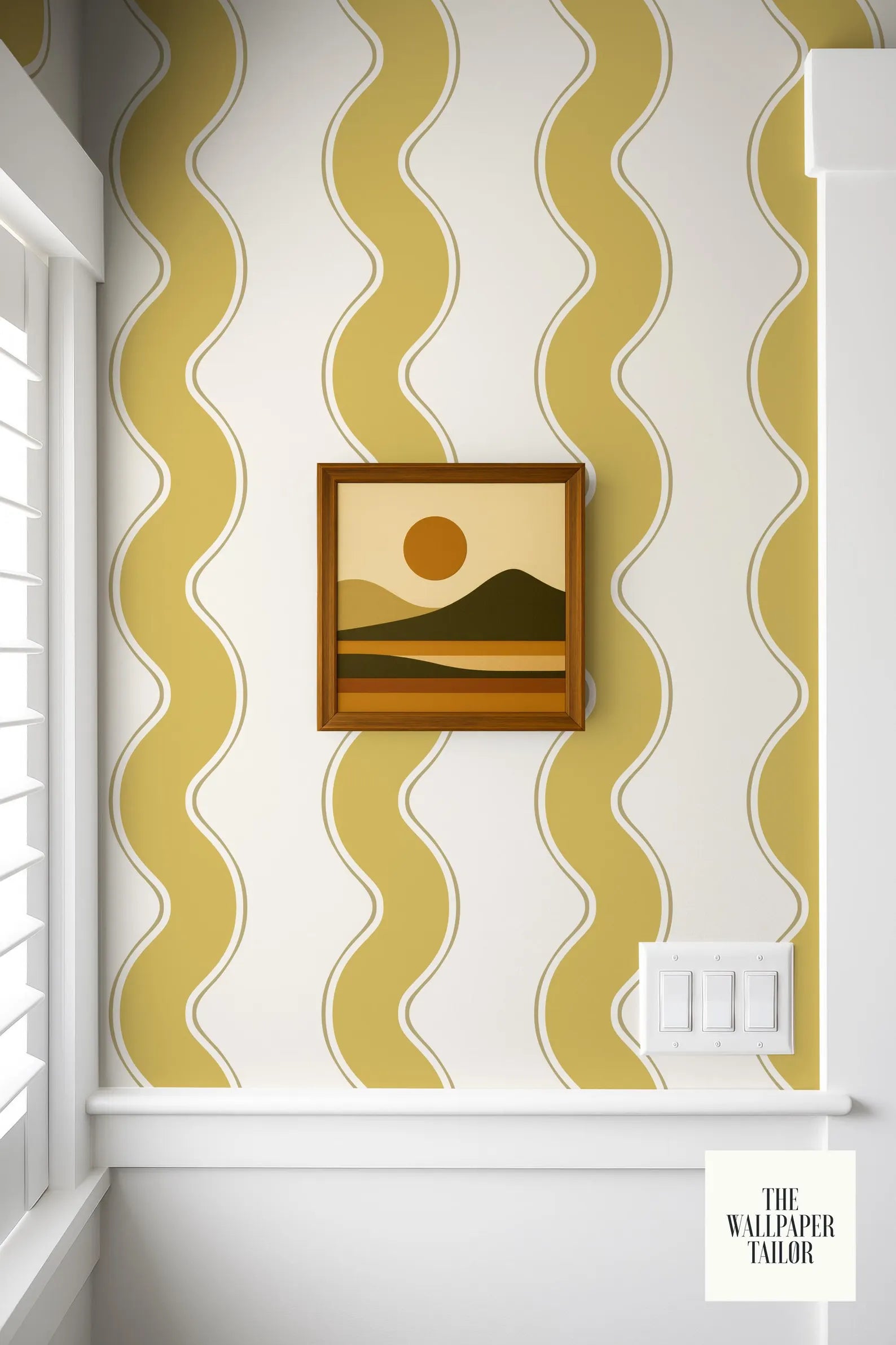 a framed landscape painting hanging on a wall with a yellow and white striped pattern.