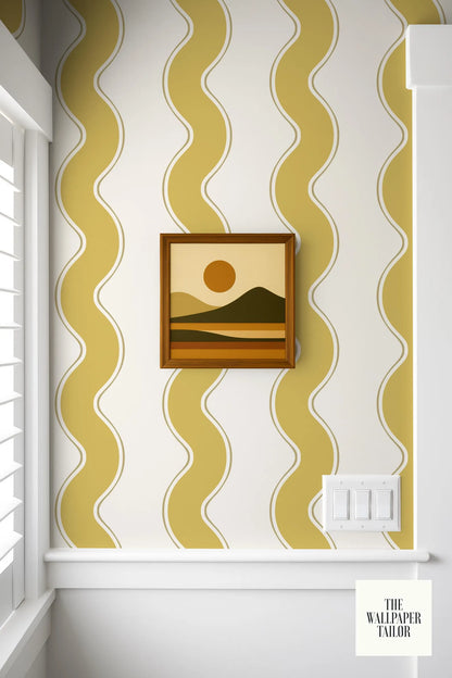 a framed landscape painting hanging on a wall with a yellow and white striped pattern.