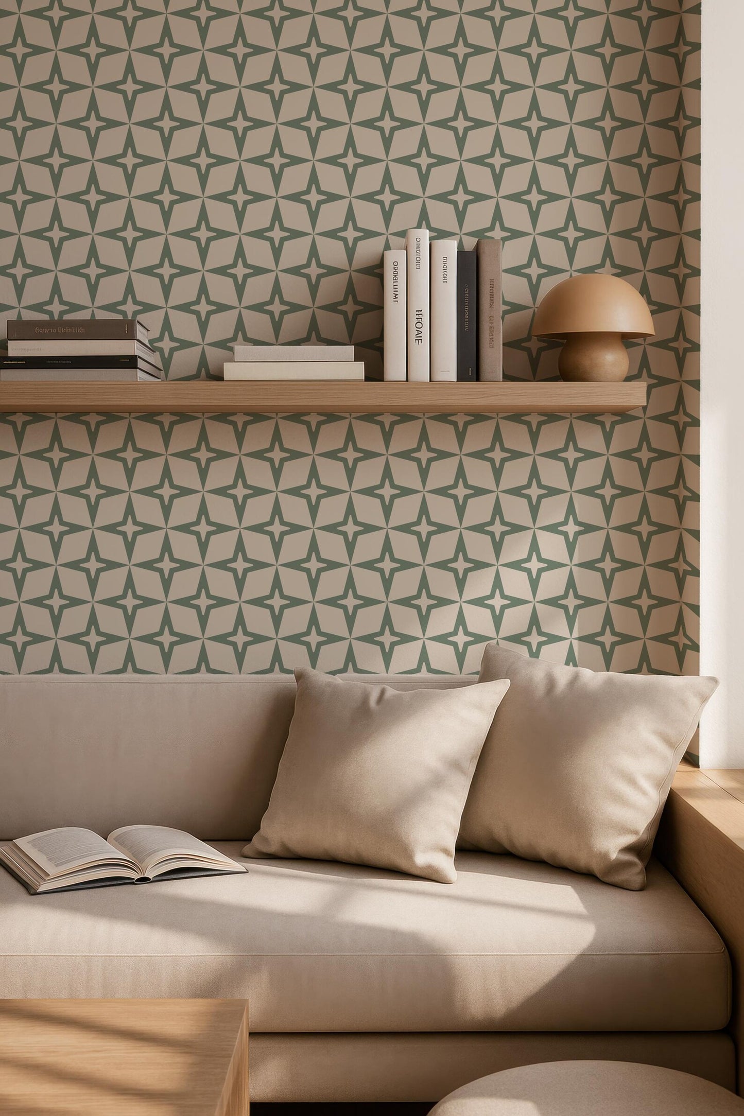 a cozy living room with a beige sofa, a wooden side table, and a bookshelf filled with books. The wall behind the sofa has a repeating pattern of green and white stars, creating a visually appealing backdrop. The room appears to be well-lit, with natural light coming in from a window.