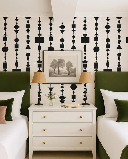 a bedroom with a white dresser, two green headboards, and a framed landscape painting on the wall. The room has a modern and stylish design with a black and white geometric pattern on the wall.