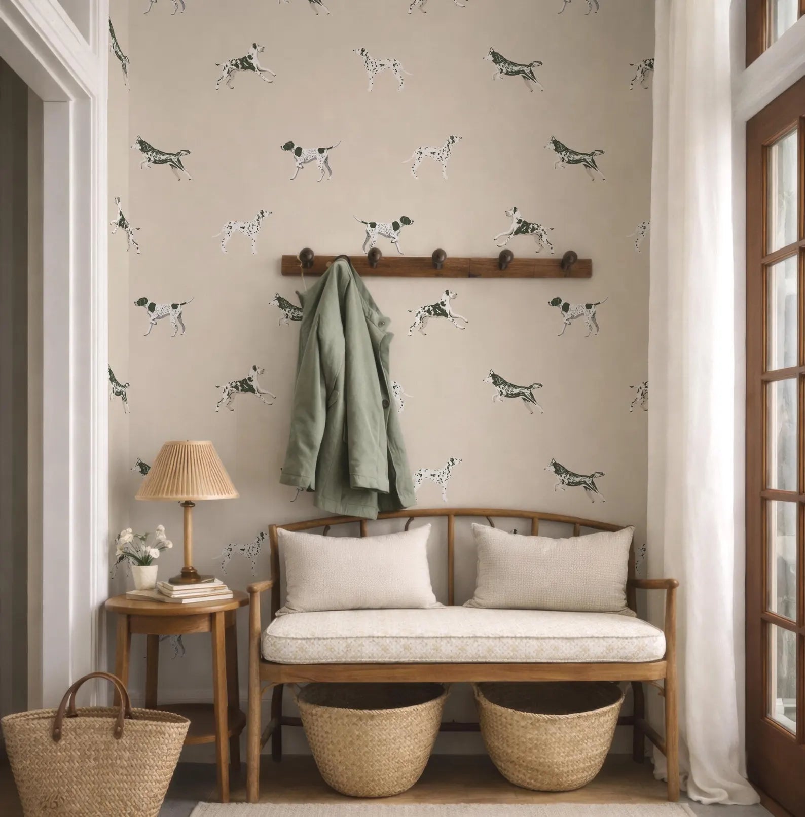 a cozy entryway with a bench, a coat rack, and a lamp. The wall behind the bench is decorated with a pattern of black and white dogs.