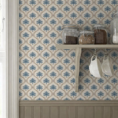 a kitchen shelf with various jars and containers, including a white bowl, against a wall with a blue and white patterned wallpaper.