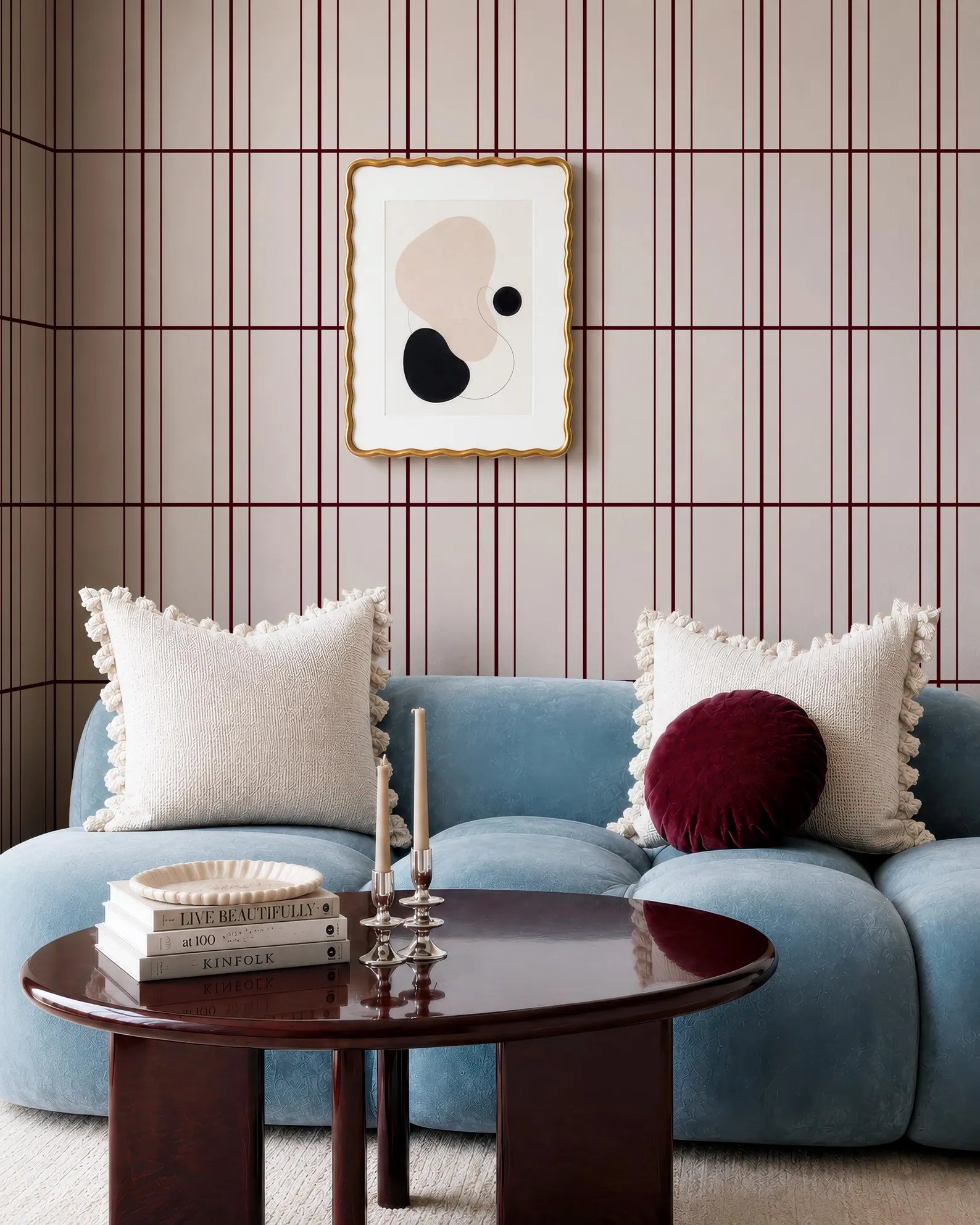 a cozy living room with a blue sofa, a wooden coffee table, and a framed abstract artwork on the wall.