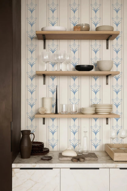 a kitchen counter with three shelves, each holding various kitchen items such as plates, bowls, and glasses. The shelves are made of wood and have a white and blue patterned design. The counter also has a marble top, and there are some decorative items like a vase and a stack of plates on it.