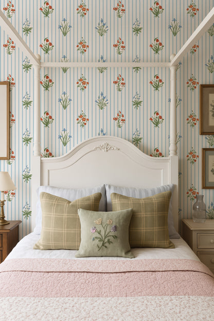 a cozy bedroom with a white canopy bed, a floral wallpaper, and a pink and white bedspread.