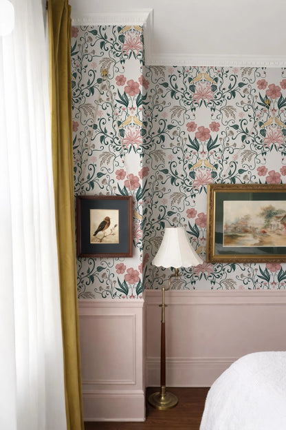 a bedroom with a floral wallpaper, a lamp, and two framed pictures on the wall.