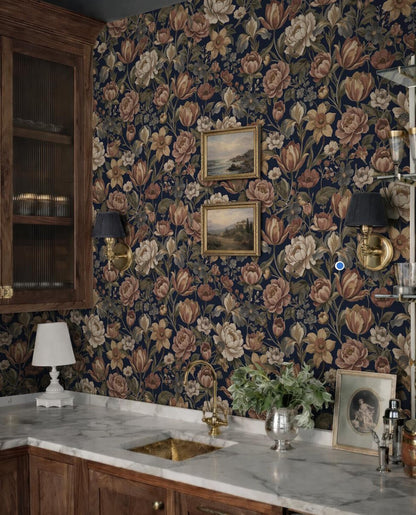 a kitchen with a dark floral wallpaper, a marble countertop, and a sink. There are two framed pictures hanging on the wall above the sink, and a vase of flowers on the countertop. The overall scene has a vintage and elegant aesthetic.