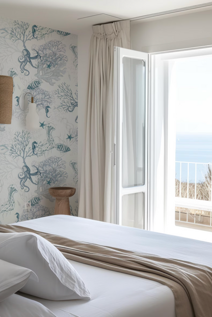 a serene bedroom with a large bed, a window with a view of the ocean, and a curtain.
