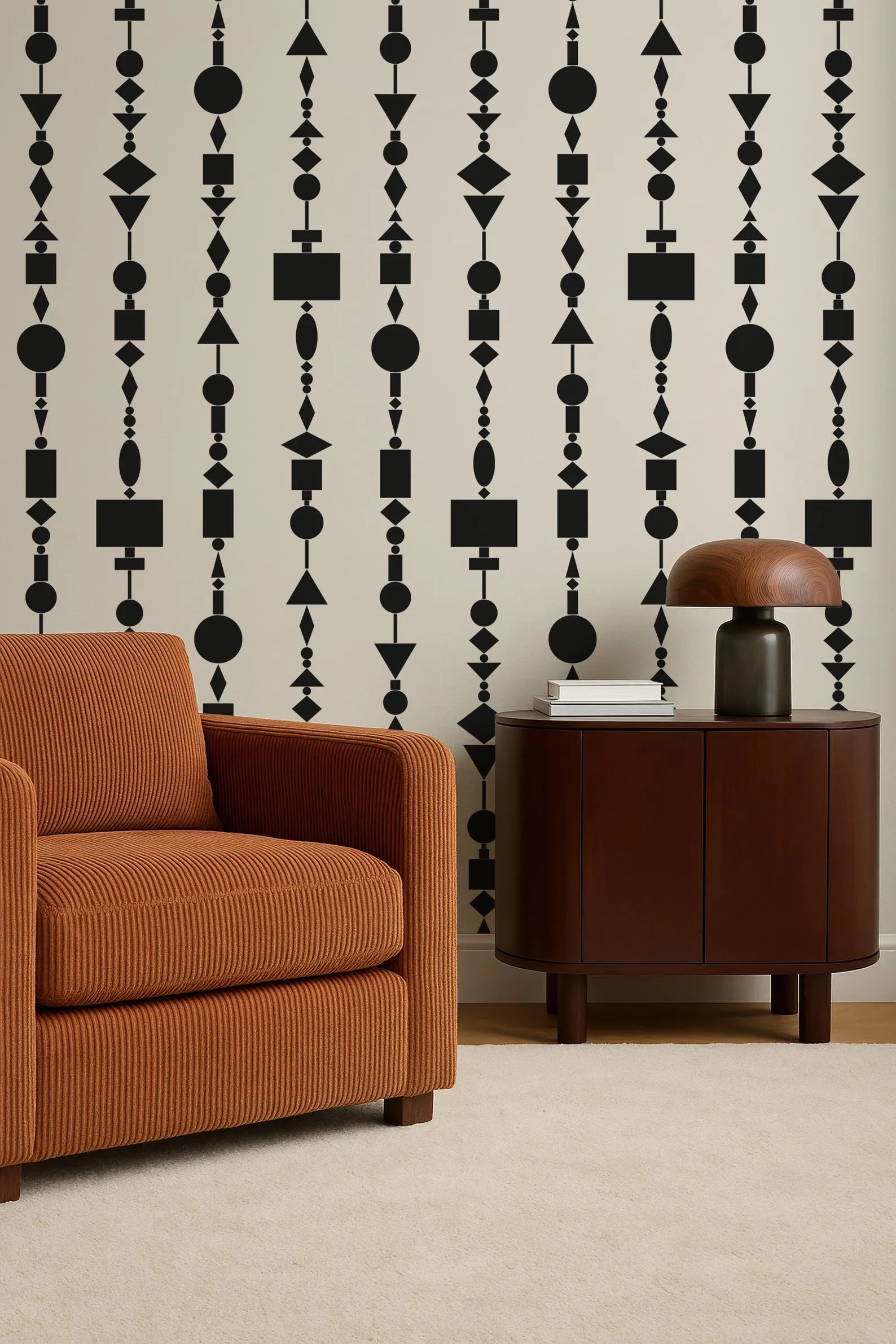 a modern living room with a brown armchair, a wooden side table, and a lamp on the table. The wall behind the furniture has a repeating pattern of black geometric shapes, creating a bold and contemporary design.
