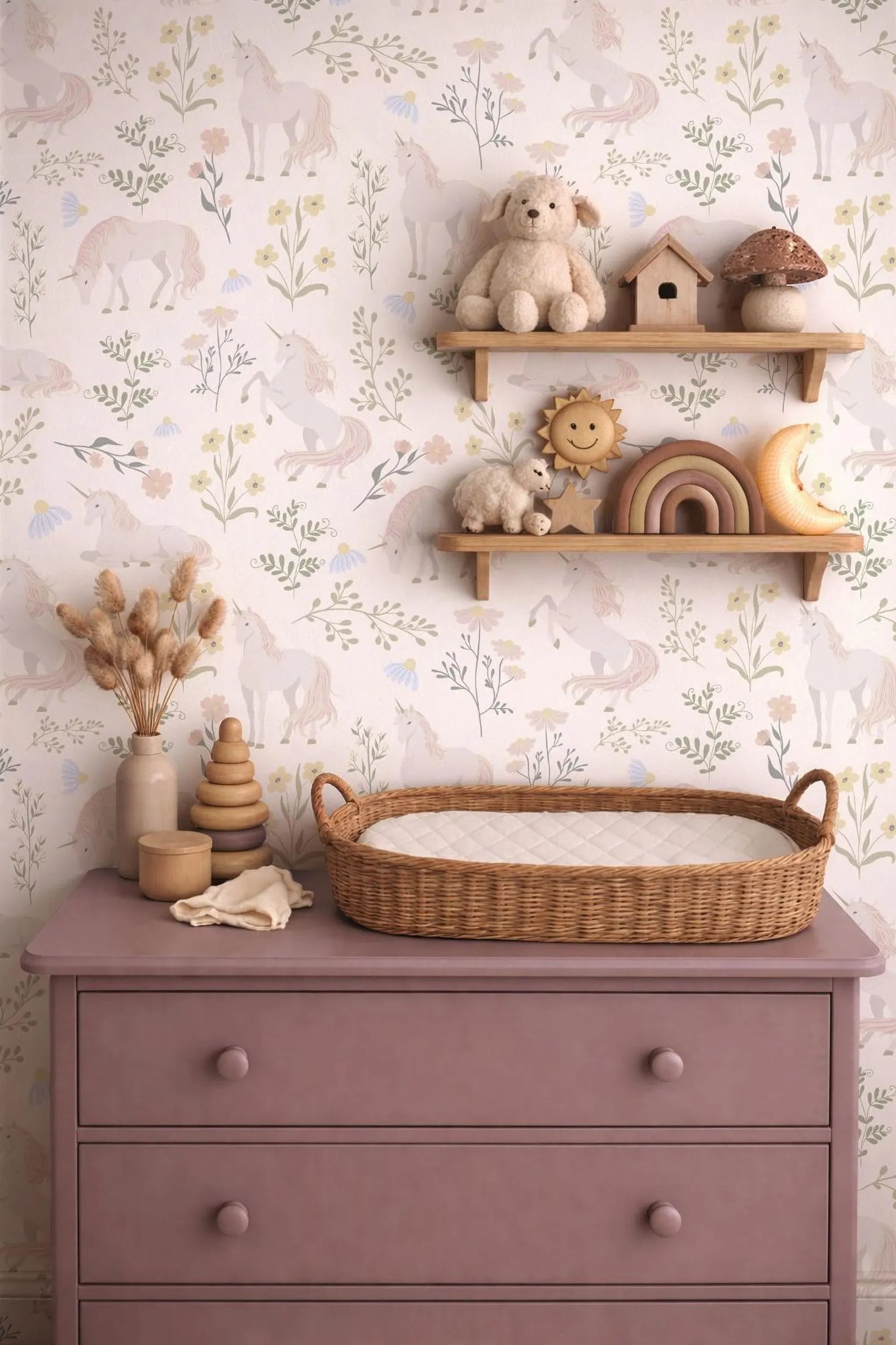 a pink dresser with a changing pad, a wicker basket, and various toys and decorations, including a wooden shelf with a stuffed animal and a wooden house.
