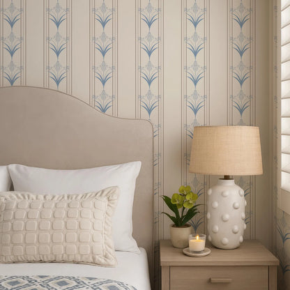 a cozy bedroom scene with a bed, a lamp, and a decorative wallpapered wall.