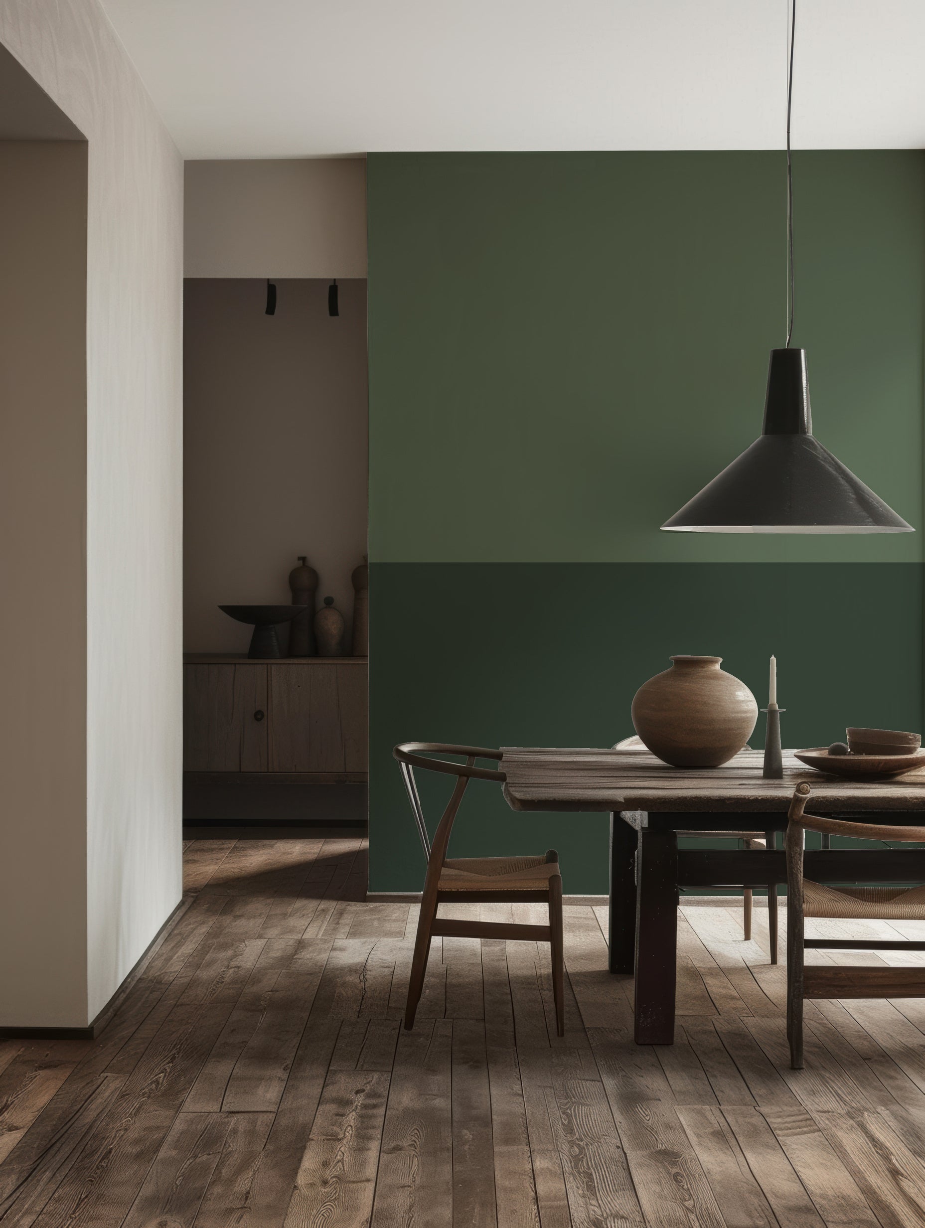 a dining room with green walls and a wooden table