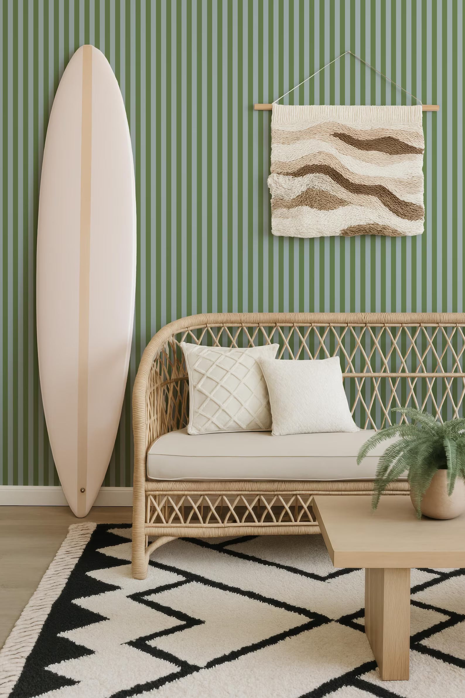 a living room with a white surfboard leaning against the wall, a wicker sofa with white pillows, a woven coffee table, and a geometric rug on the floor.
