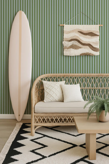 a living room with a white surfboard leaning against the wall, a wicker sofa with white pillows, a woven coffee table, and a geometric rug on the floor.