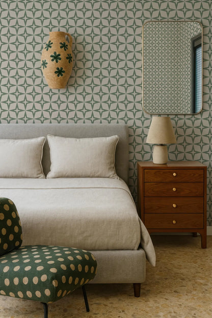 a modern bedroom with a gray bed, a wooden nightstand, and a green and white polka dot chair. The room has a geometric patterned wallpaper and a mirror on the wall.