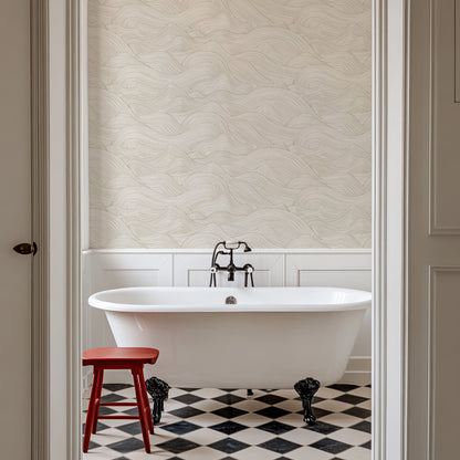 a white bath tub sitting next to a red stool