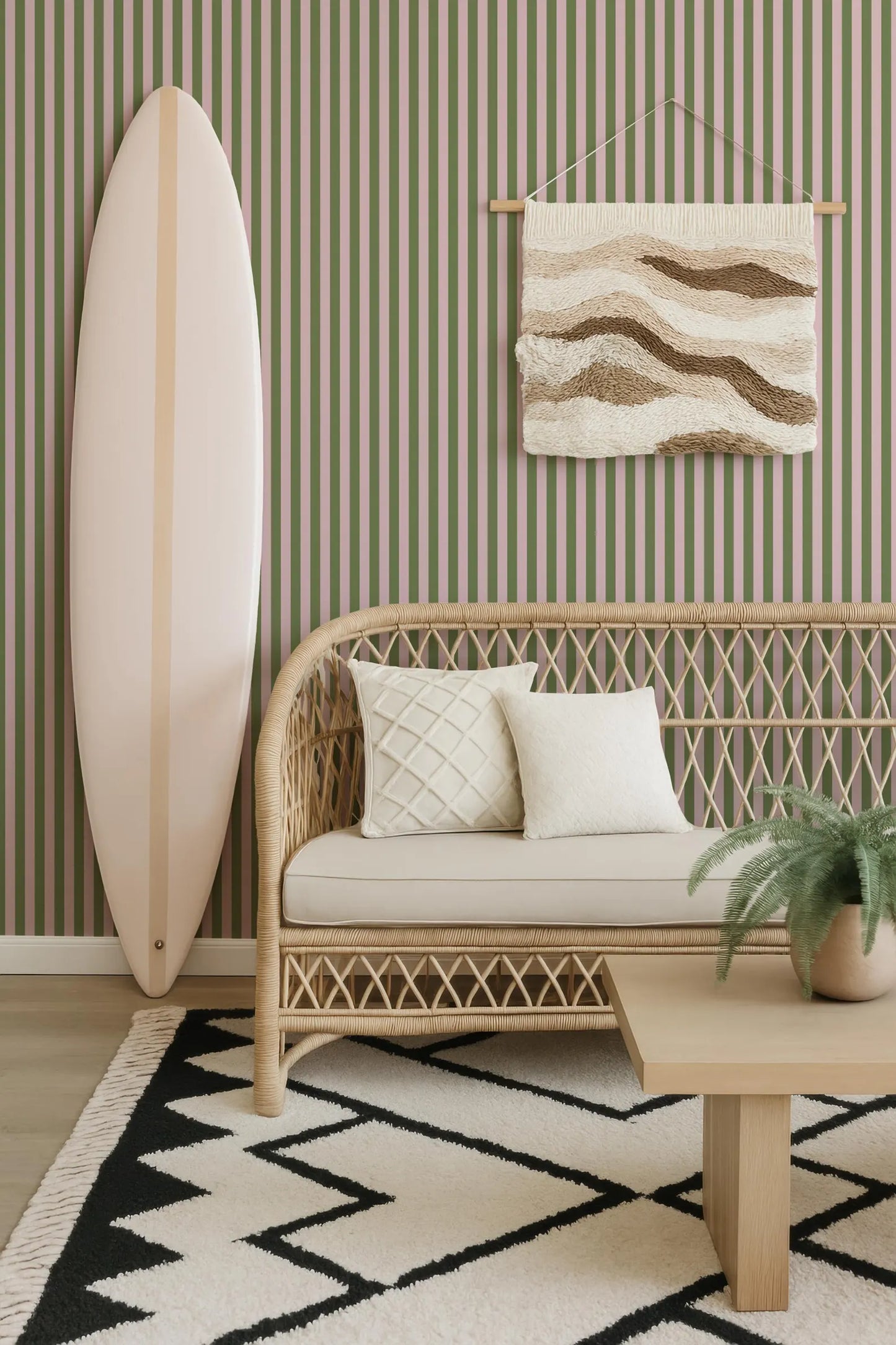 a living room with a wicker sofa, a wooden coffee table, a surfboard leaning against the wall, and a woven rug on the floor.