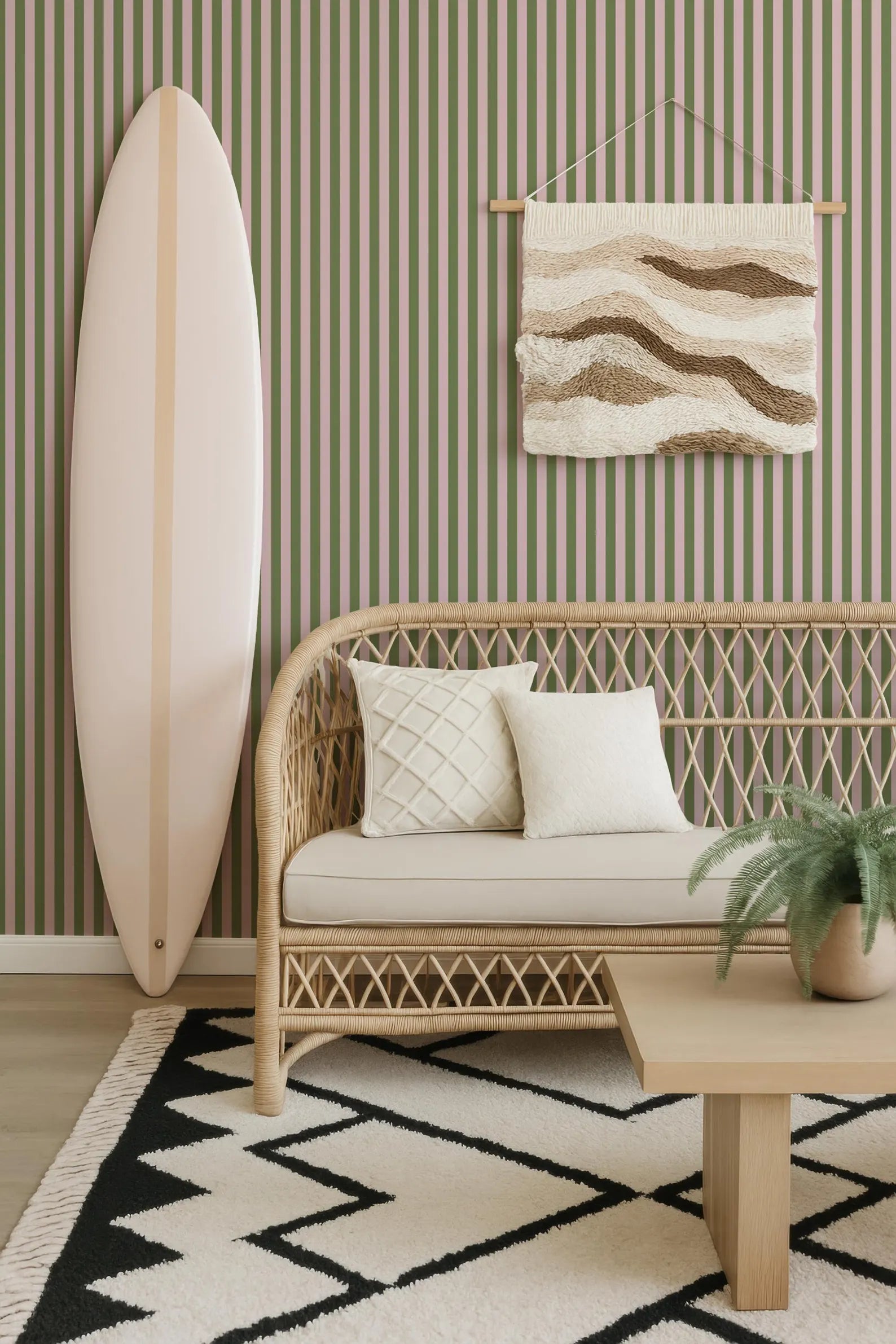 a living room with a wicker sofa, a wooden coffee table, a surfboard leaning against the wall, and a woven rug on the floor.