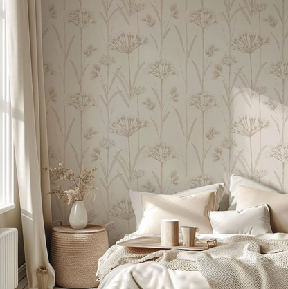 a cozy bedroom scene with a bed adorned with white pillows and a beige blanket. A tray with a coffee cup and saucer is placed on the bed, and a vase of flowers is also present. The room features a patterned wallpaper with a floral design, and a window with curtains can be seen on the left side of the image.