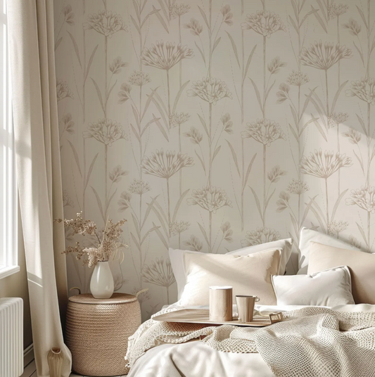 a cozy bedroom scene with a bed adorned with white pillows and a beige blanket. A tray with a coffee cup and saucer is placed on the bed, and a vase of flowers is also present. The room features a patterned wallpaper with a floral design, and a window with curtains can be seen on the left side of the image.
