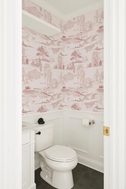 a bathroom with a white toilet and a pink and white wallpaper pattern on the walls.