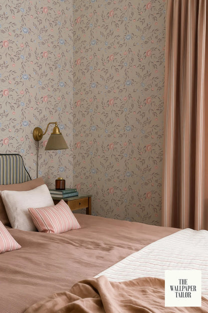 a cozy bedroom with a floral wallpaper, a bed with a pink and white striped comforter, and a nightstand with a lamp.