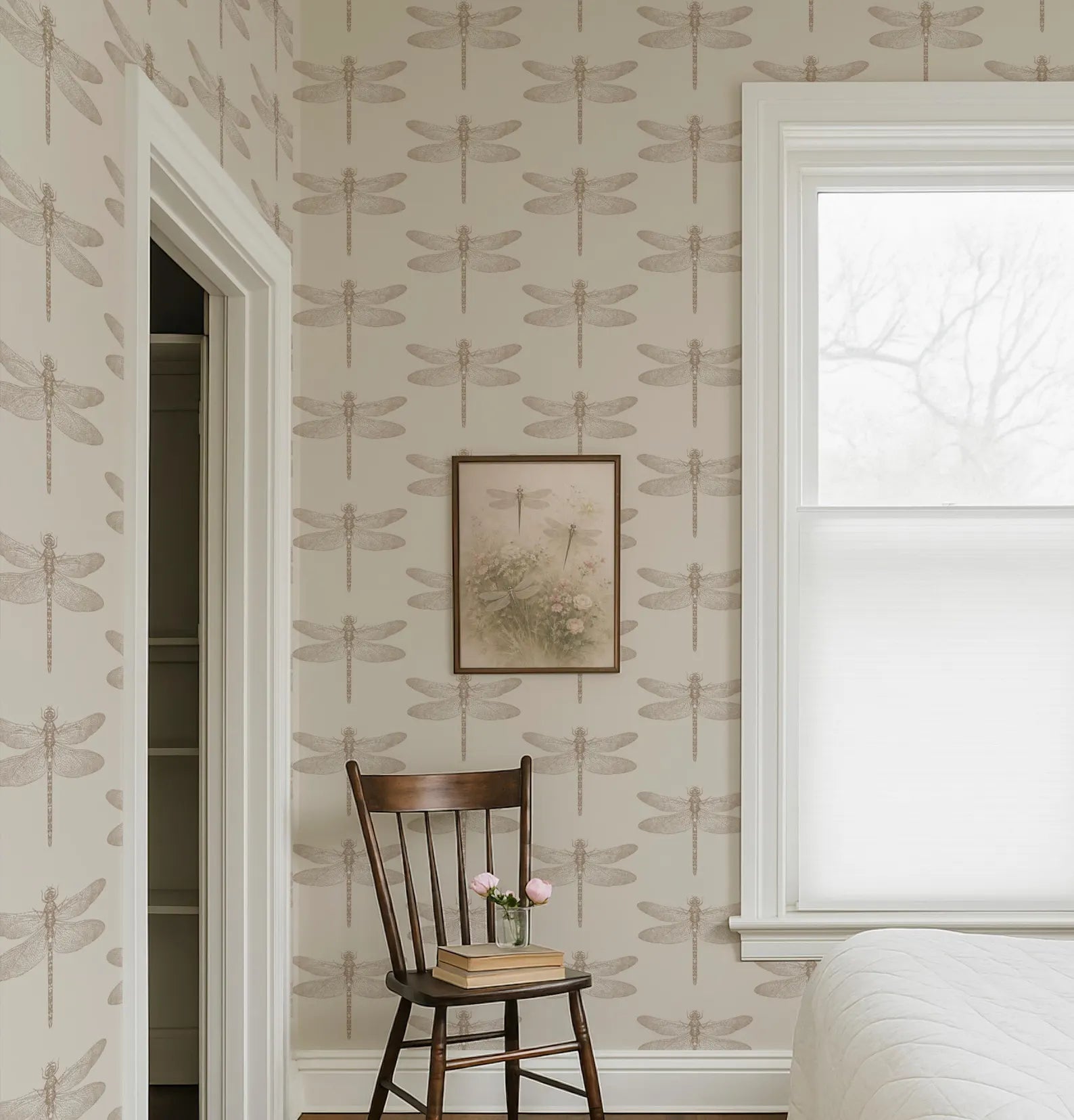 a bedroom with a wooden chair, a framed picture of a dragonfly, and a window with white blinds. The walls are covered in a repeating pattern of dragonfly designs, creating a cohesive and visually appealing space.