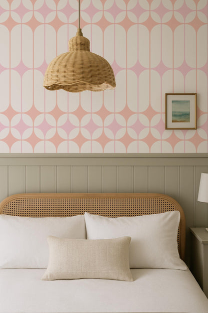 a cozy bedroom with a bed, a wicker pendant lamp, and a framed picture on the wall.