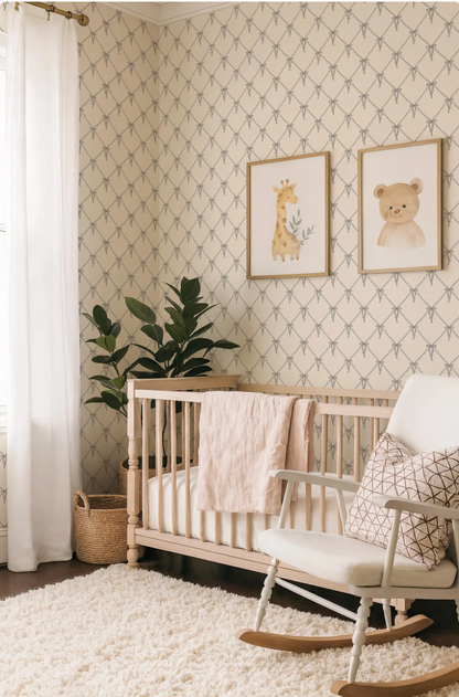 a cozy nursery with a white crib, a rocking chair, and a potted plant. The walls are decorated with a patterned wallpaper, and there are two framed animal pictures on the wall.