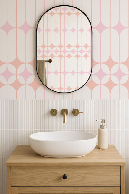 a bathroom with a white oval-shaped sink, a wooden vanity, and a mirror above it. The walls are decorated with a pink and white geometric pattern.