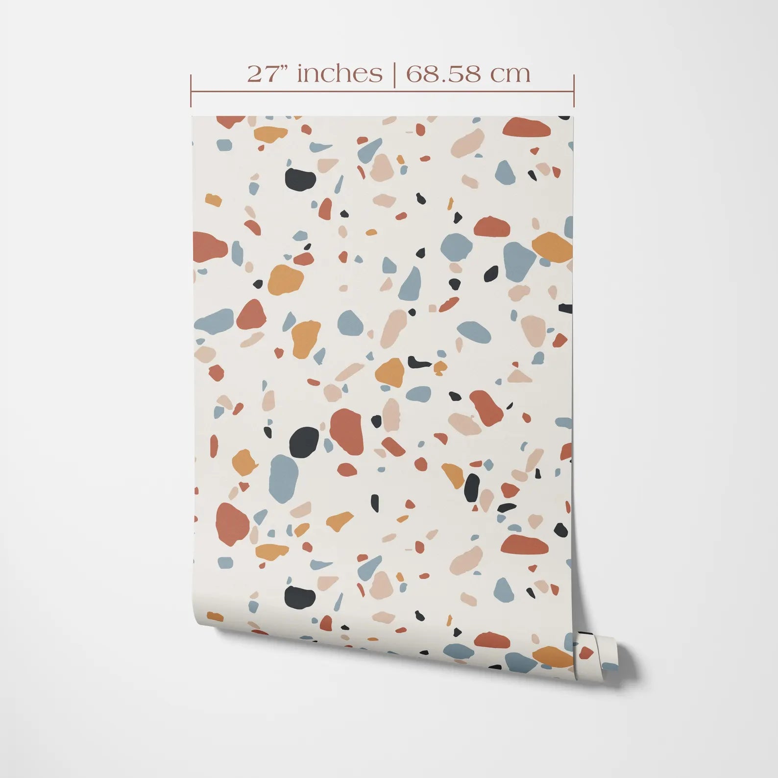 a pattern of multicolored pebbles or stones on a white background, with a measurement scale indicating the size of the pattern in inches and centimeters.