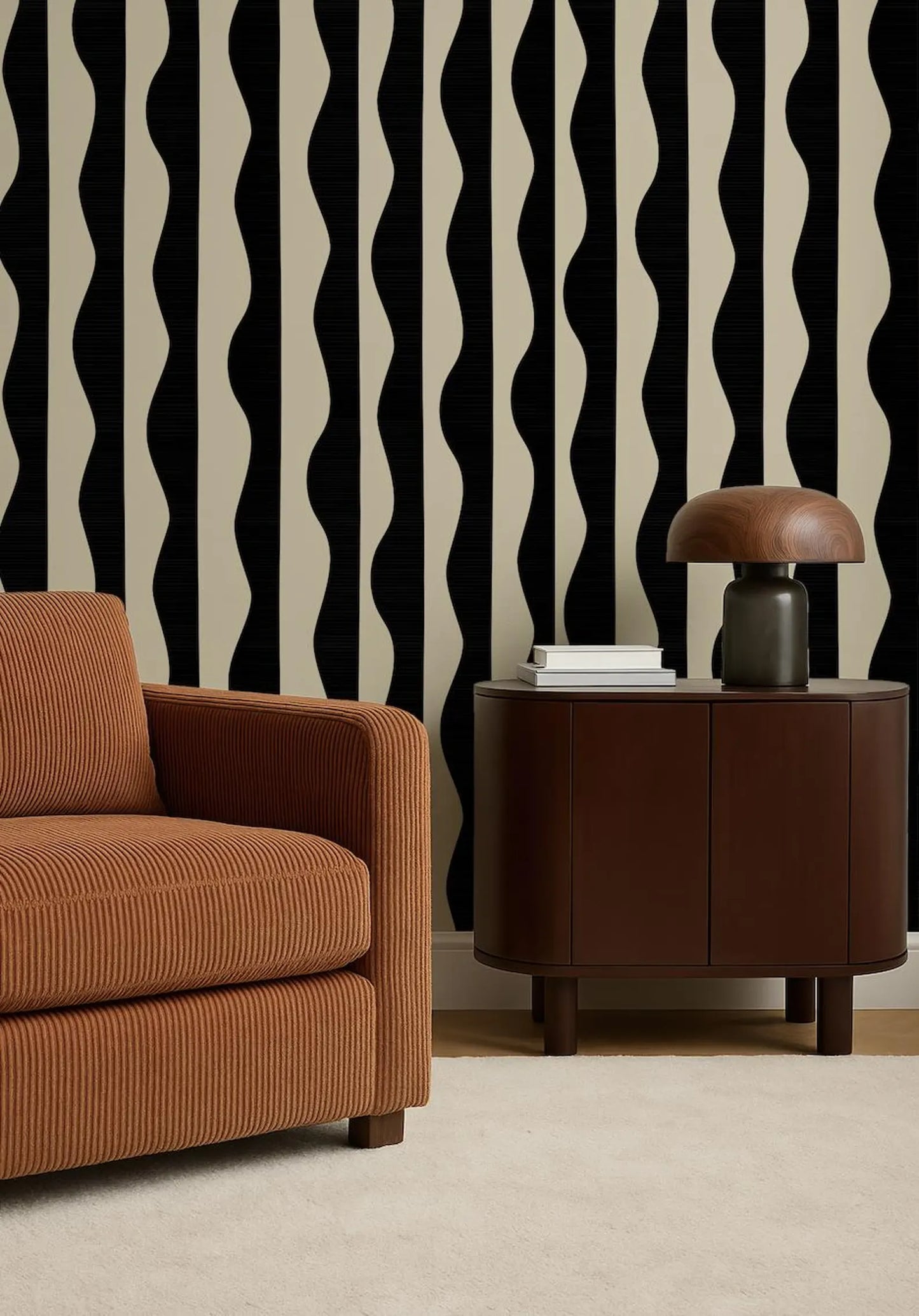 a modern living room with a brown sofa, a wooden side table, and a lamp on top of the side table. The wall behind the furniture has a black and white striped pattern.