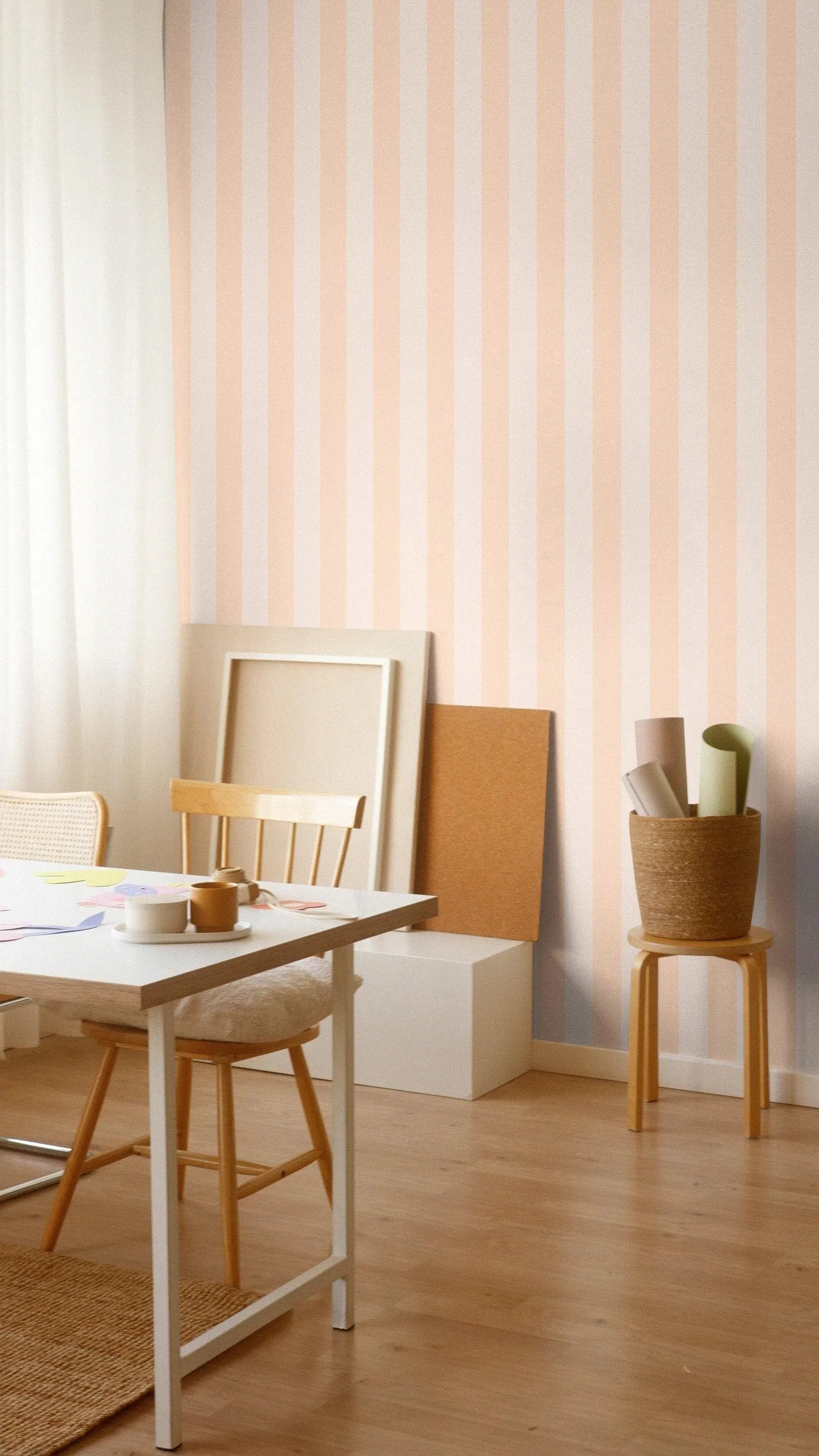 a cozy and well-organized workspace with a wooden table, chairs, and a basket on the floor. The walls are adorned with striped wallpaper, and the room has a warm and inviting atmosphere.