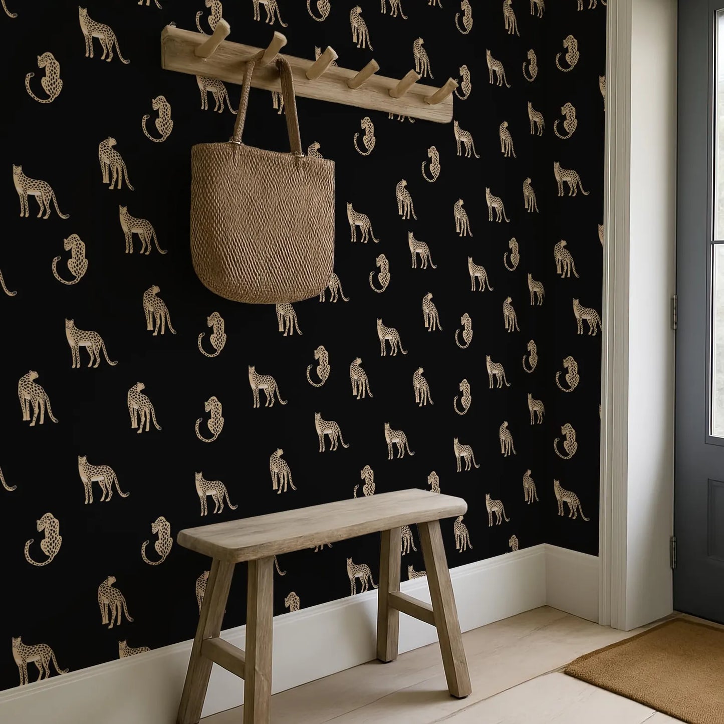 a black and white wall with a repeating pattern of leopard silhouettes, creating a striking visual effect. A wooden bench is positioned in front of the wall, and a woven bag is hanging on a wooden rack above it.