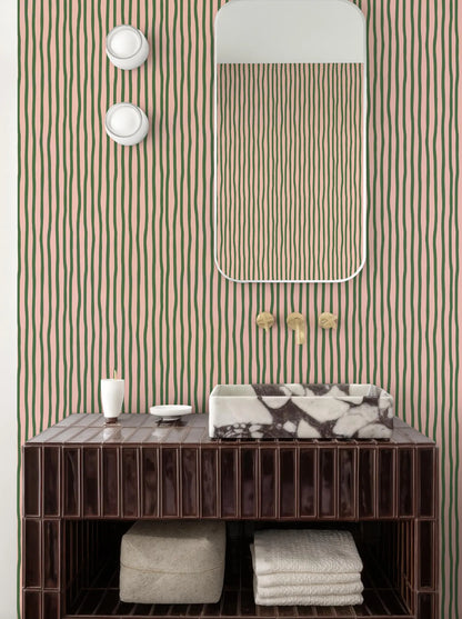 a bathroom with a brown wooden vanity, a marble-topped sink, and a striped wallpaper. The bathroom also includes a mirror and a shelf below the vanity.